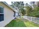 Small, grassy backyard with white vinyl fence at 30817 Prout Ct, Wesley Chapel, FL 33543