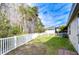 Fenced backyard with grassy area and white vinyl fence at 30817 Prout Ct, Wesley Chapel, FL 33543