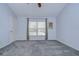 Spacious bedroom with grey carpet, window, and ceiling fan at 30817 Prout Ct, Wesley Chapel, FL 33543