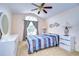 Spacious bedroom with a ceiling fan and large window at 30817 Prout Ct, Wesley Chapel, FL 33543