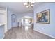 Bright dining room with hardwood floors and view into living room at 30817 Prout Ct, Wesley Chapel, FL 33543