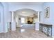 Elegant entryway with arched doorway leading to living room and hardwood floors at 30817 Prout Ct, Wesley Chapel, FL 33543