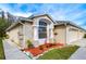 House exterior showcasing a three-car garage and manicured yard at 30817 Prout Ct, Wesley Chapel, FL 33543