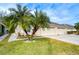 House exterior with three-car garage and lush landscaping at 30817 Prout Ct, Wesley Chapel, FL 33543