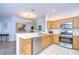 Well-equipped kitchen featuring stainless steel appliances and light wood cabinets at 30817 Prout Ct, Wesley Chapel, FL 33543