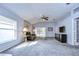 Bright living room with a vaulted ceiling, grey carpet and patio access at 30817 Prout Ct, Wesley Chapel, FL 33543