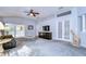 Bright living room featuring a comfy leather couch and built-in entertainment center at 30817 Prout Ct, Wesley Chapel, FL 33543