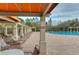 Relaxing pool area with covered seating and lounge chairs at 30817 Prout Ct, Wesley Chapel, FL 33543