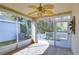 Bright screened porch with ceiling fan and tiled floor at 30817 Prout Ct, Wesley Chapel, FL 33543