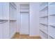 Large walk-in closet with shelves and hanging rods at 30817 Prout Ct, Wesley Chapel, FL 33543