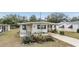 Landscaped mobile home with a carport at 36810 Kay Ave, Zephyrhills, FL 33542