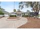 Community building exterior, featuring landscaping and signage at 3780 Pinebrook Cir # 106, Bradenton, FL 34209