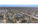 Wide aerial view showing the neighborhood, including a pond and distant cityscape at 3992 60Th N St, St Petersburg, FL 33709