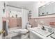 Pink tiled bathroom with a tub, toilet and vanity at 3992 60Th N St, St Petersburg, FL 33709