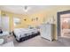 King-size bed, white wicker dresser and ensuite bath at 3992 60Th N St, St Petersburg, FL 33709