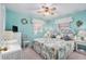 Serene main bedroom with a light blue wall and wicker furniture at 3992 60Th N St, St Petersburg, FL 33709