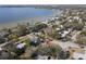 Aerial view of a house near the water, with a large yard and trees at 400 Country Club Dr, Oldsmar, FL 34677