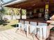 Covered outdoor bar with tiki decor at 400 Country Club Dr, Oldsmar, FL 34677