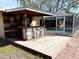 Rustic outdoor bar with stools near pool at 400 Country Club Dr, Oldsmar, FL 34677