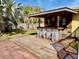 Tiki-themed outdoor bar with seating area at 400 Country Club Dr, Oldsmar, FL 34677