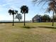 Open green space with palm trees and a waterfront pavilion at 400 Country Club Dr, Oldsmar, FL 34677