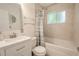 Bathroom with tub, shower, and updated vanity at 404 Manor Blvd, Palm Harbor, FL 34683