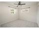 Bedroom with tile floors, ceiling fan and two windows at 404 Manor Blvd, Palm Harbor, FL 34683