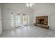 Bright Gathering room with fireplace and sliding doors to patio at 404 Manor Blvd, Palm Harbor, FL 34683