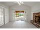 Bright Gathering room with fireplace and sliding doors to patio at 404 Manor Blvd, Palm Harbor, FL 34683