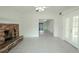 Living room with tile floors, brick fireplace, and view of the kitchen at 404 Manor Blvd, Palm Harbor, FL 34683