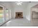 Living room with brick fireplace and tile floors, open to the kitchen at 404 Manor Blvd, Palm Harbor, FL 34683