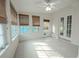 Sunroom featuring tile floors, window blinds, and French doors leading outside at 404 Manor Blvd, Palm Harbor, FL 34683