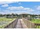 Wooden dock with gazebo overlooking a serene lake at 4128 Dolphin Dr, Tampa, FL 33617