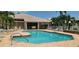 Inviting community pool with lounge chairs and tables, perfect for relaxing and socializing with neighbors at 4415 Muirfield, Bradenton, FL 34210