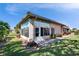 Home exterior showcasing a sunroom addition and well-maintained lawn at 4415 Muirfield, Bradenton, FL 34210