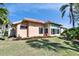 Backyard view of the home, highlighting a sunroom and landscaping at 4415 Muirfield, Bradenton, FL 34210