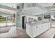 Bright and airy kitchen features white cabinetry, marble countertops, and modern stainless steel appliances at 4415 Muirfield, Bradenton, FL 34210