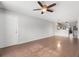 Bright living room with wood-look floors and access to front door at 4529 Whitton Way # 211, New Port Richey, FL 34653