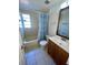 Bathroom with tub, shower, vanity, and patterned curtain at 4814 Northdale Blvd, Tampa, FL 33624