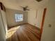 Well-lit bedroom featuring wood-look floors and a window at 4814 Northdale Blvd, Tampa, FL 33624