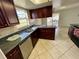 L-shaped kitchen with granite countertops and dark wood cabinets at 4814 Northdale Blvd, Tampa, FL 33624