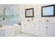 Elegant bathroom with soaking tub, double vanity, and walk-in shower at 4818 W San Rafael St, Tampa, FL 33629