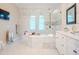 Spa-like bathroom with large soaking tub, double vanity, and glass shower at 4818 W San Rafael St, Tampa, FL 33629