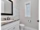 Small bathroom with updated vanity and decorative tile at 4818 W San Rafael St, Tampa, FL 33629