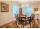 Bright dining room featuring a large table, hardwood floors and chandelier at 4818 W San Rafael St, Tampa, FL 33629