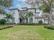 Two-story house with a white facade, brown roof, and lush landscaping at 4818 W San Rafael St, Tampa, FL 33629