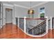 Upstairs hallway with hardwood floor and access to bedrooms at 4818 W San Rafael St, Tampa, FL 33629