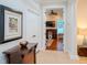 A hallway with a view into a home office and artwork on the wall at 4818 W San Rafael St, Tampa, FL 33629