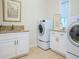 Laundry room with washer, dryer, cabinets and granite countertop at 4818 W San Rafael St, Tampa, FL 33629