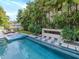 Resort-style pool with swim up loungers, spa and lush landscaping at 4818 W San Rafael St, Tampa, FL 33629